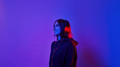 Eine lächelnde Frau mit Kopfhörer auf